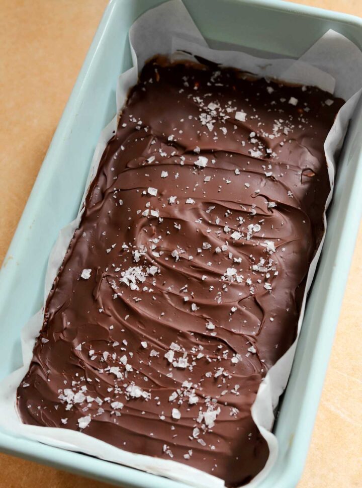 healthy snickers bars topped with chocolate after chilling to set