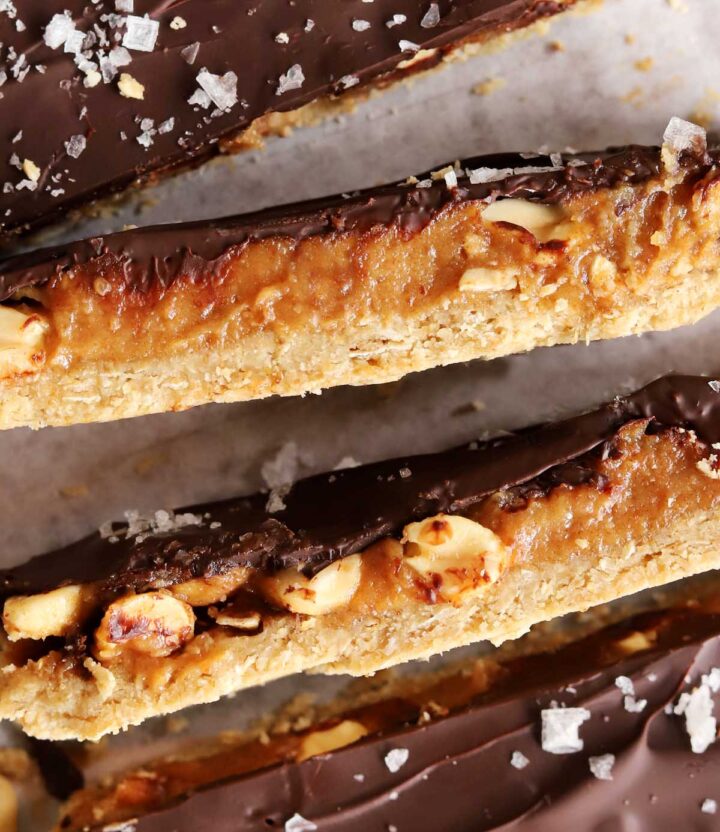 top view of healthy snickers bars sliced on parchment paper showing cross section and all layers