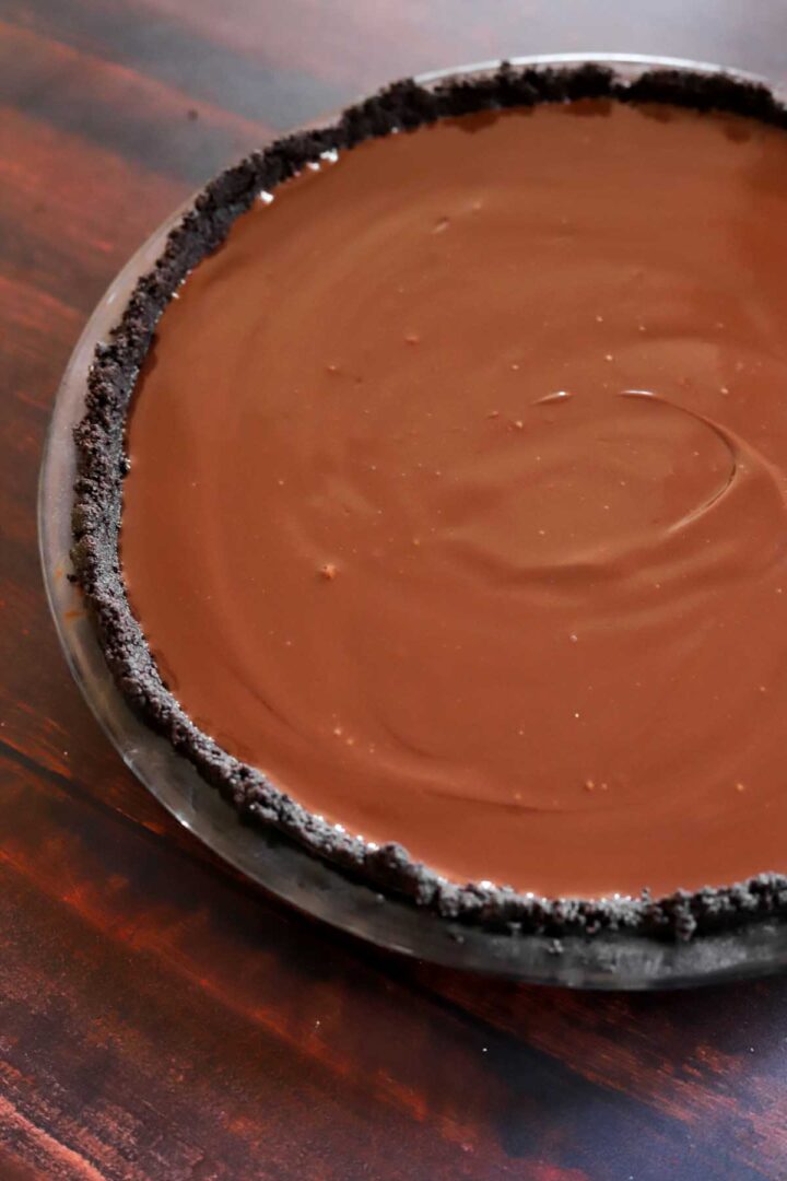 Oreo cookie crust with chocolate cream filling ready for chilling