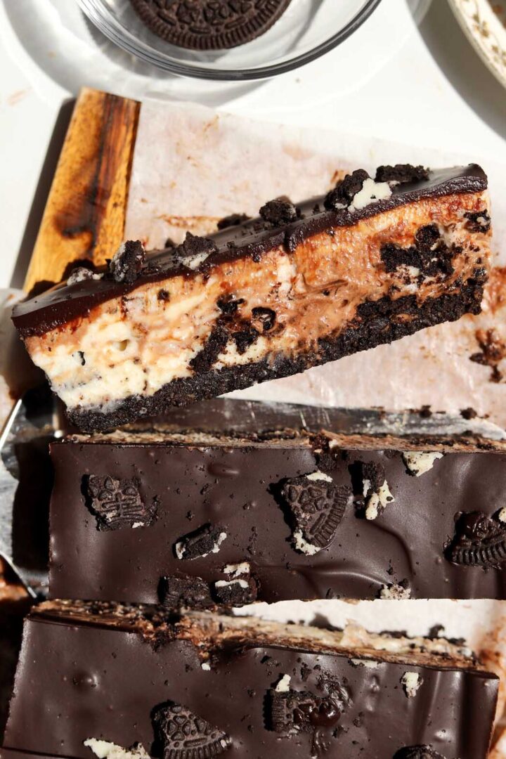 top view of no bake Oreo cheesecake bars slice on cutting board