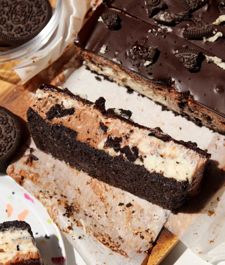 no bake Oreo cheesecake bars slice on cutting board
