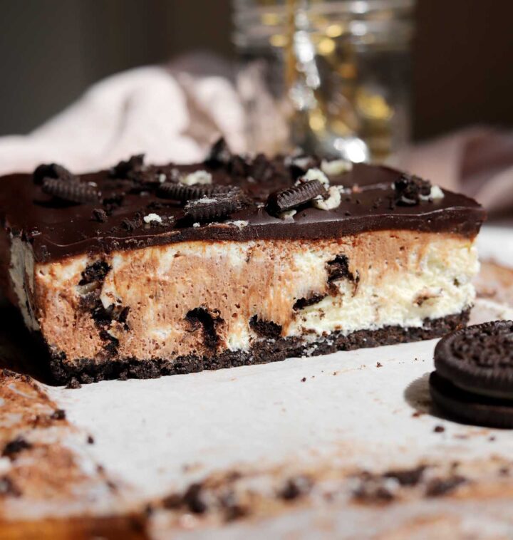 no bake Oreo cheesecake bars slice on cutting board