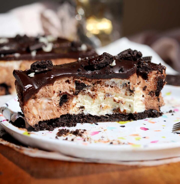 slice of no bake Oreo cheesecake on a plate with bite
