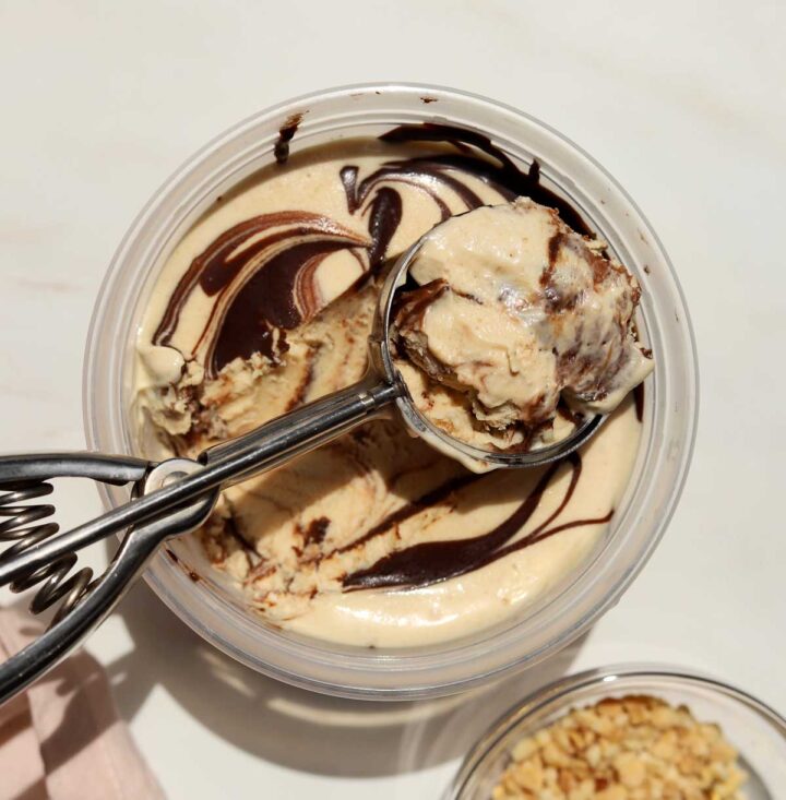 no churn peanut butter espresso fudge ice cream in deli container with scoop