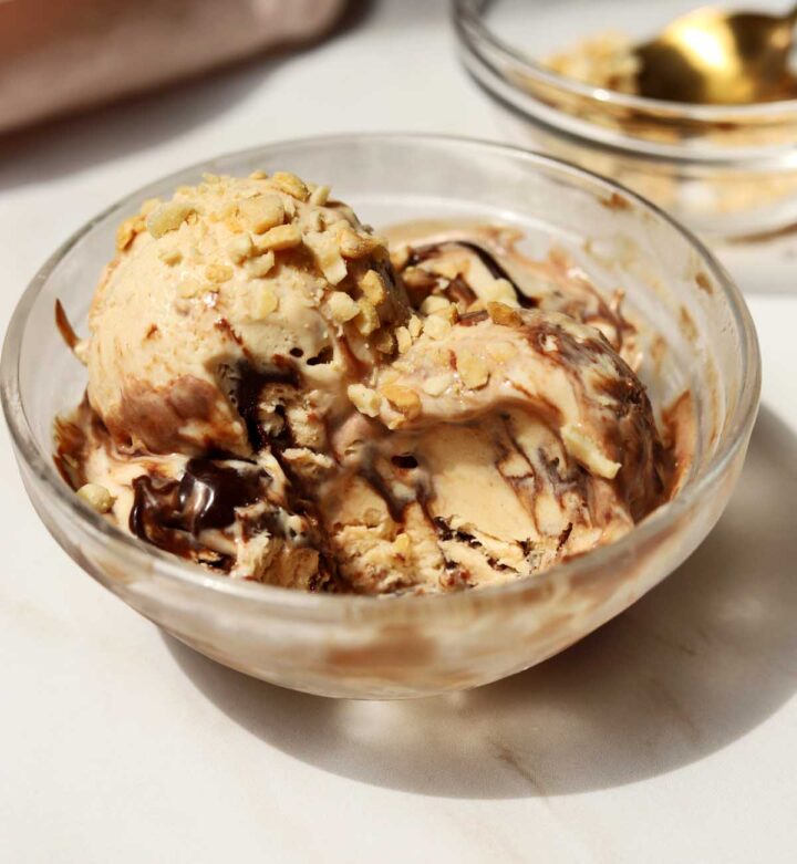 scoops of no churn peanut butter espresso fudge ice cream in a bowl with bite