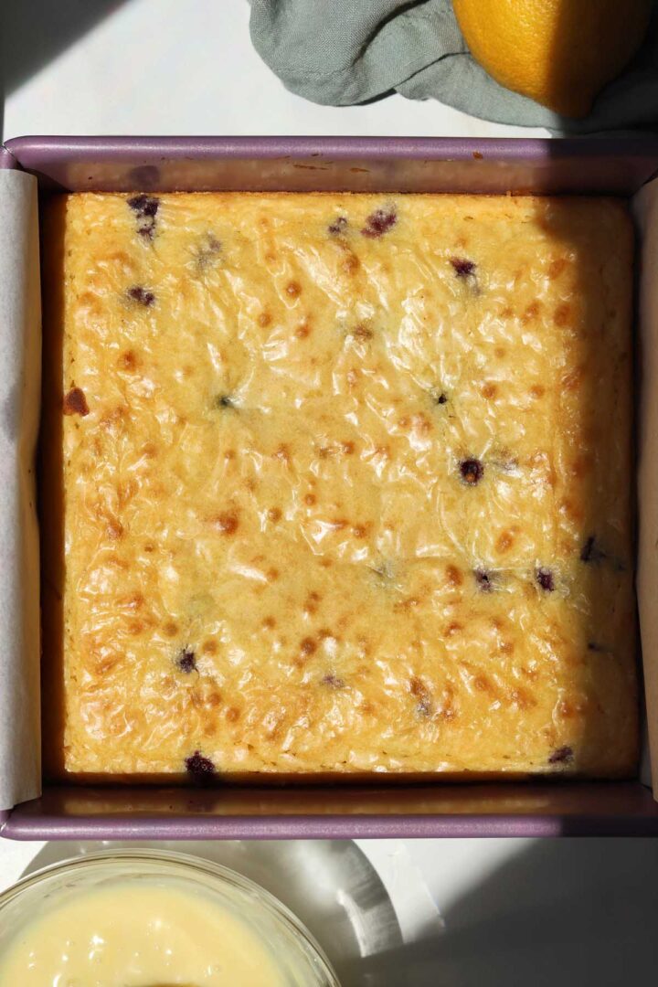lemon blueberry brownies in baking pan after baking with shiny crust