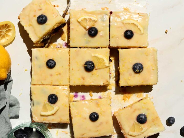 top view of fudgy lemon blueberry brownies sliced on parchment paper