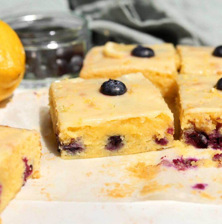 fudgy lemon blueberry brownies sliced on parchment paper