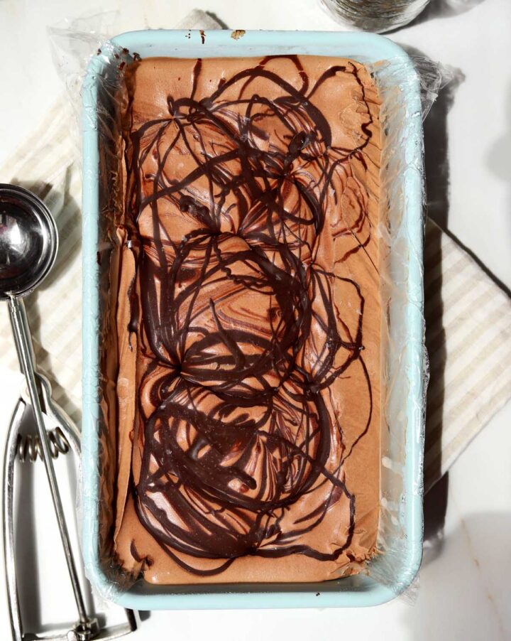 no churn chocolate crackle ice cream in loaf pan before scooping