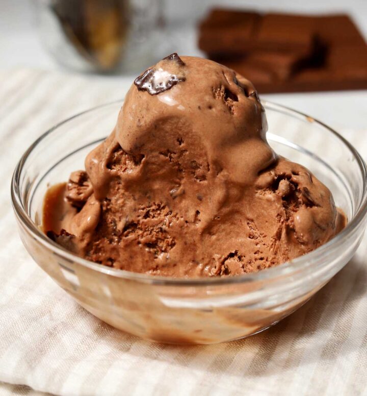 no churn chocolate crackle ice cream scoops in a bowl with bite