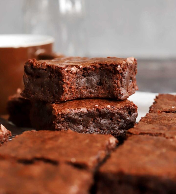 fudgy egg white brownies stacked on parchment paper