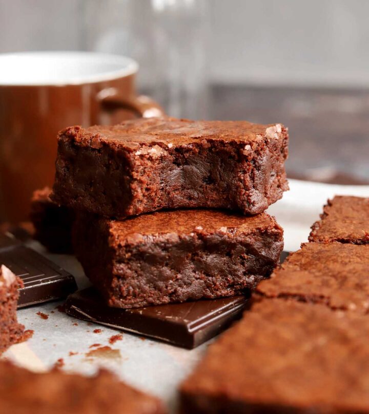 fudgy egg white brownies stacked on parchment paper