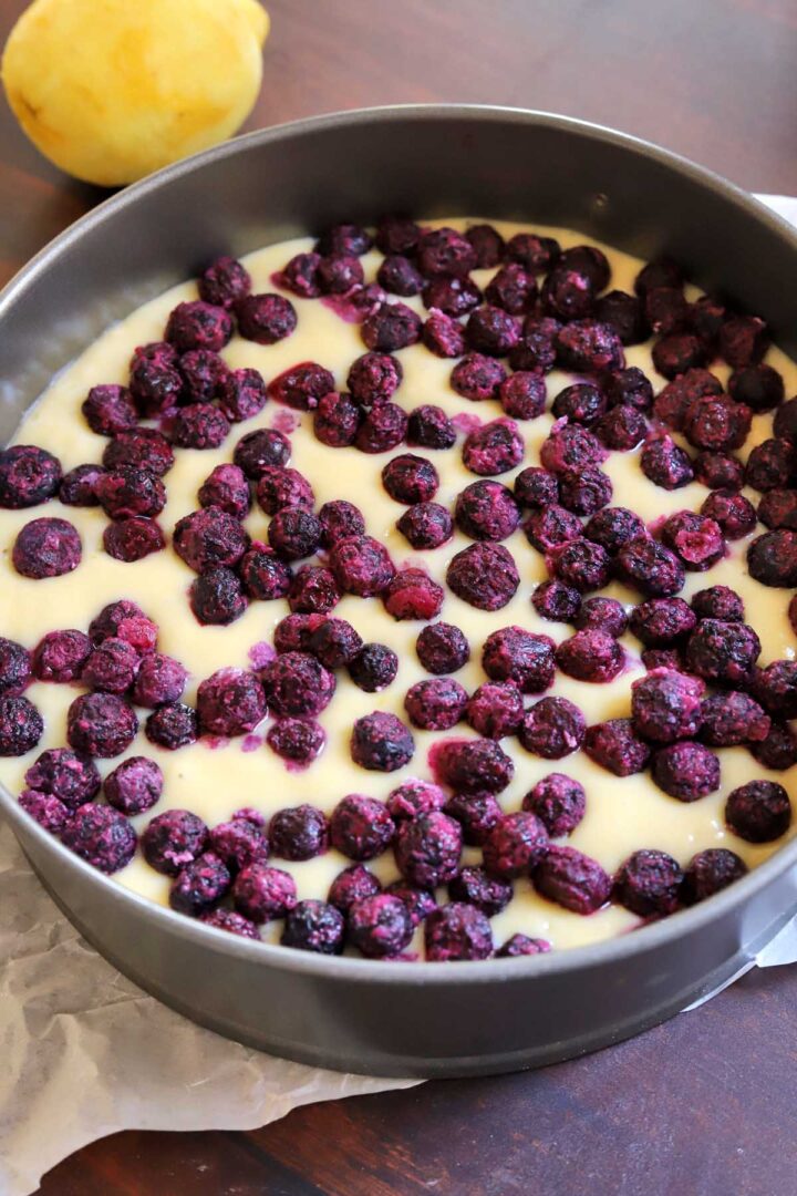 lemon blueberry yogurt cake batter in baking pan before baking