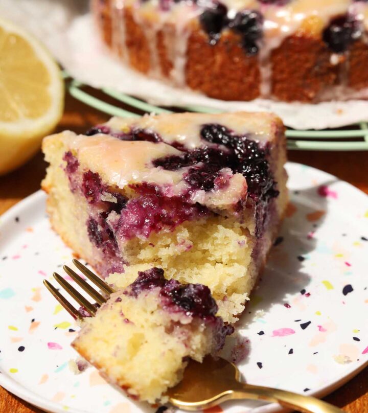 slice of lemon blueberry yogurt cake on a plate with bite and fork