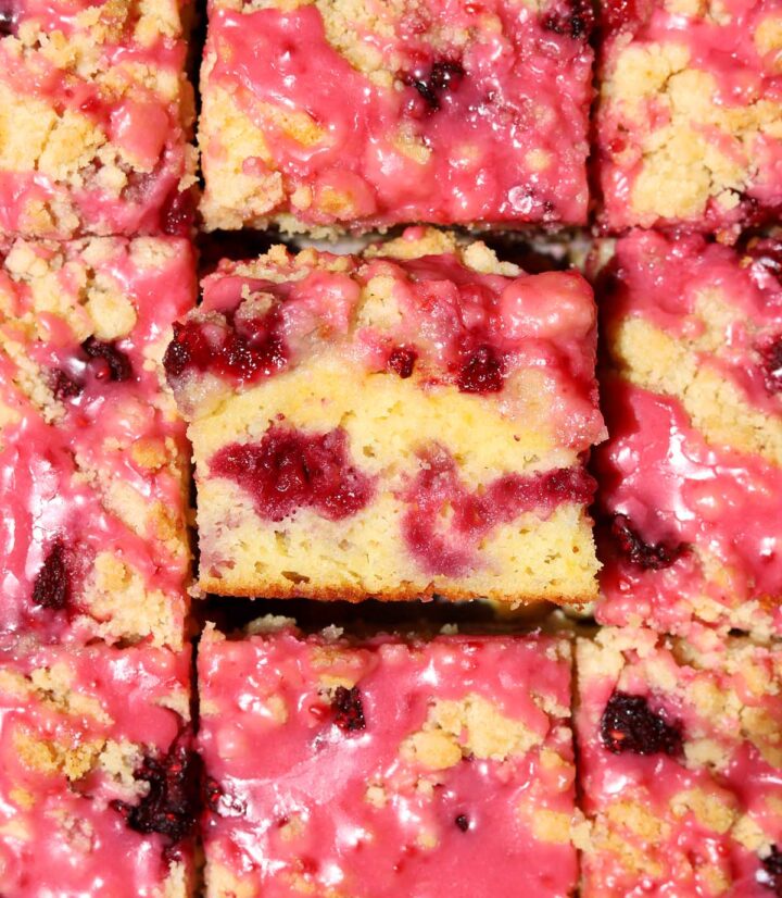 top view of raspberry lemonade coffee cake sliced on serving board