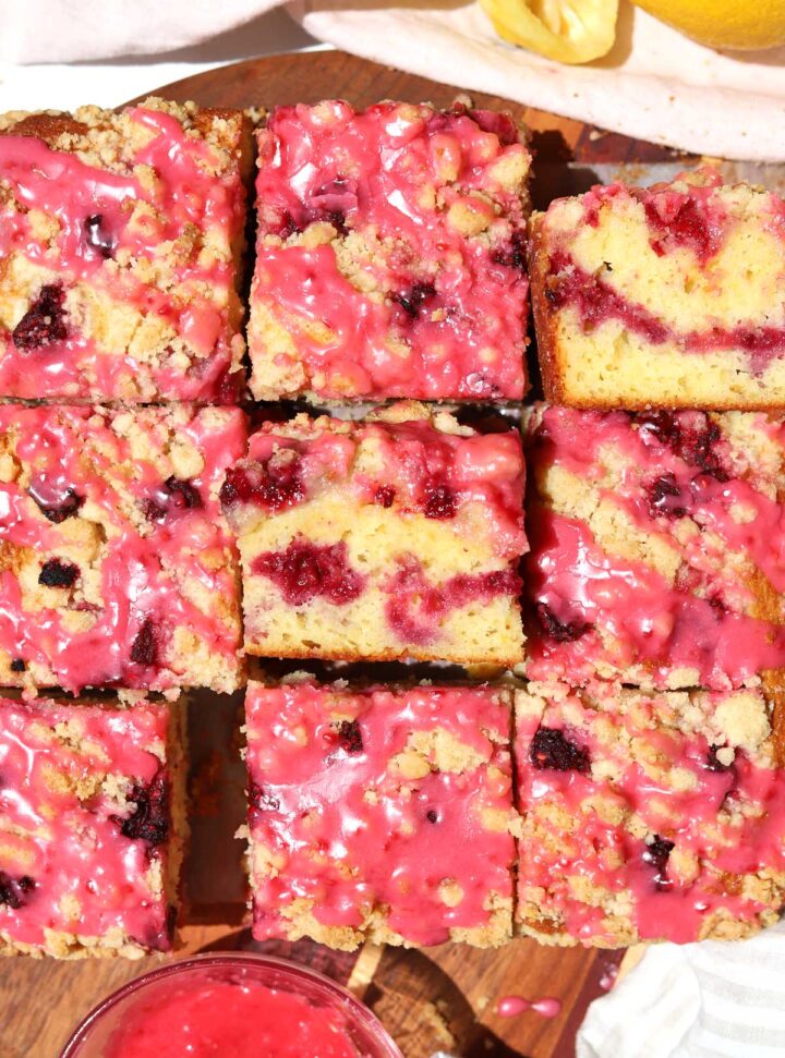top view of raspberry lemonade coffee cake sliced on serving board
