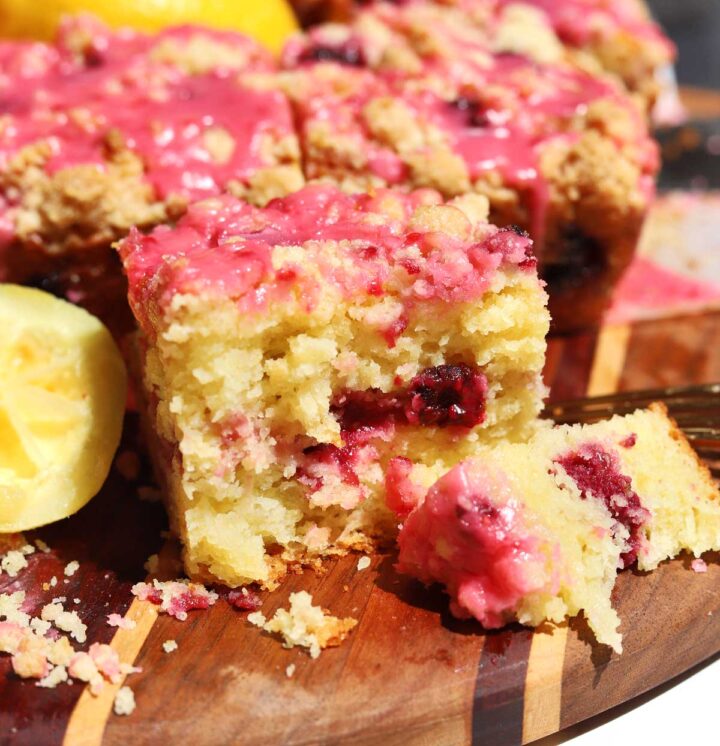 raspberry lemonade coffee cake on serving board with bite and fork