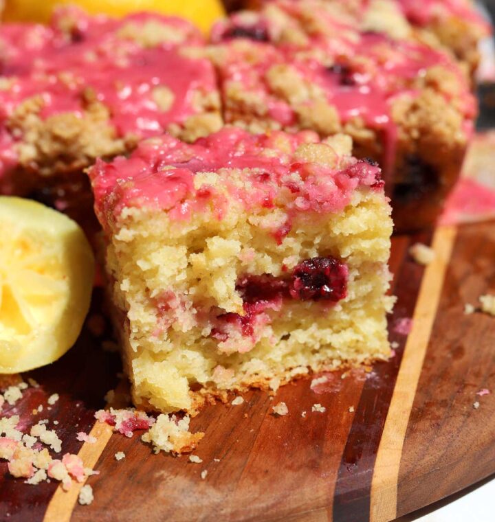 raspberry lemonade coffee cake on serving board with bite