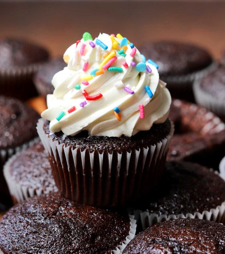 best hybrid vanilla American buttercream piped over a chocolate cupcake with sprinkles