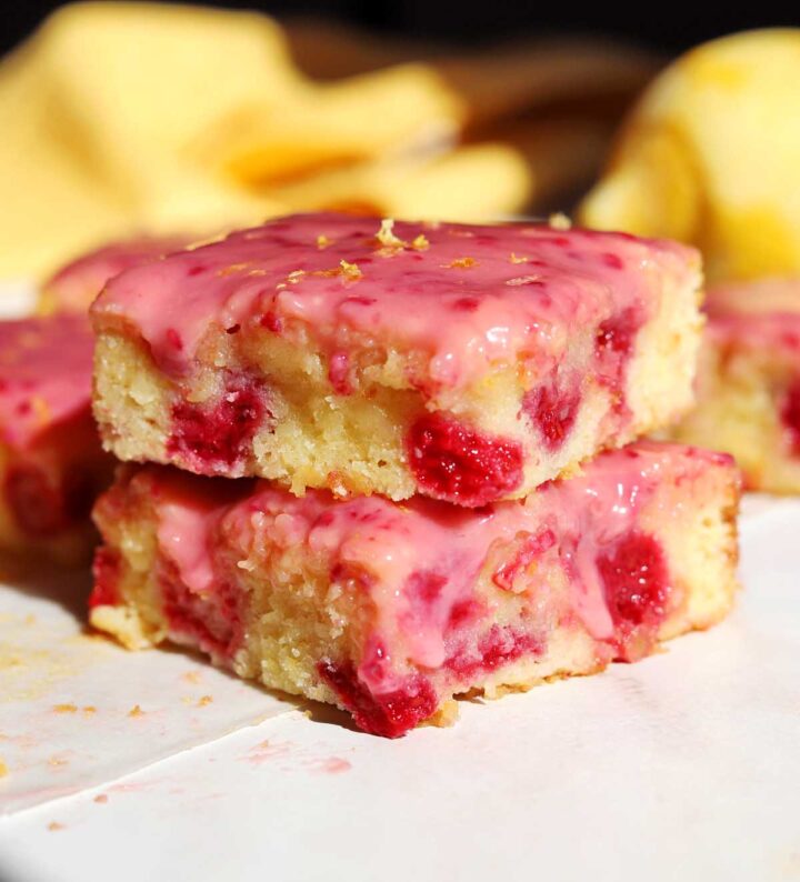 raspberry lemonade brownies stacked on cutting board