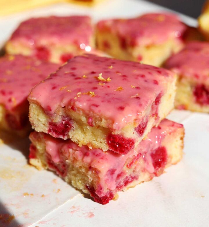 raspberry lemonade brownies stacked on cutting board
