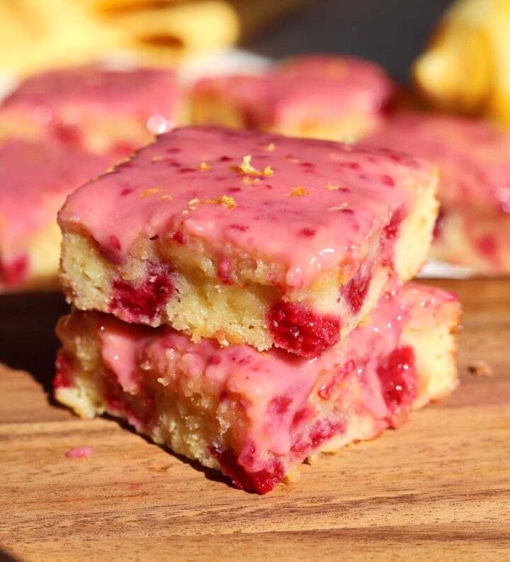raspberry lemonade brownies stacked on cutting board