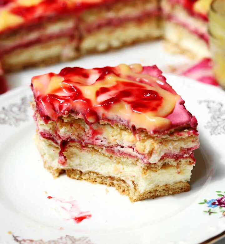 raspberry lemonade icebox cake slice on a plate with bite