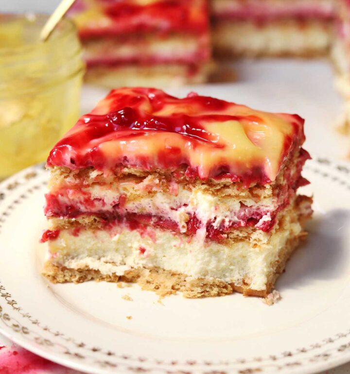raspberry lemonade icebox cake slice on a plate with bite