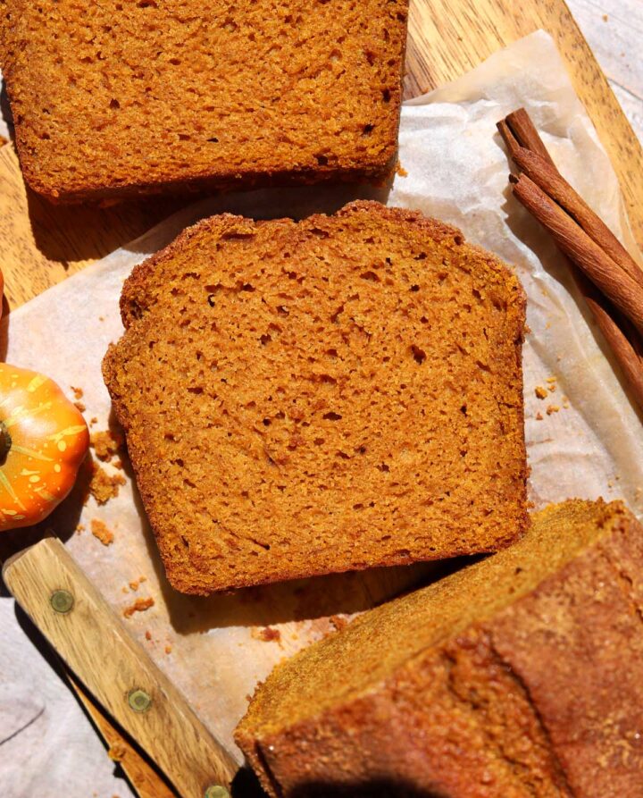 top view of the best pumpkin bread slice on cutting board