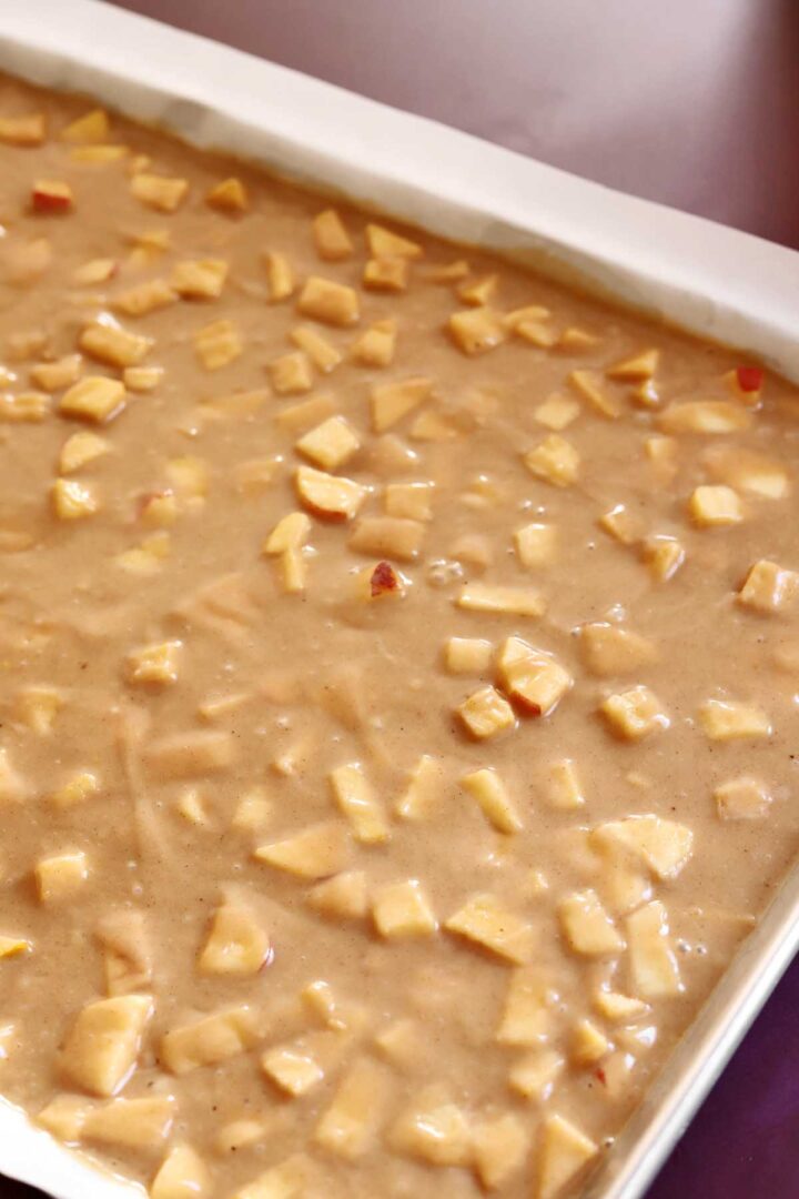 top view of apple fritter Texas sheet cake batter in baking before baking