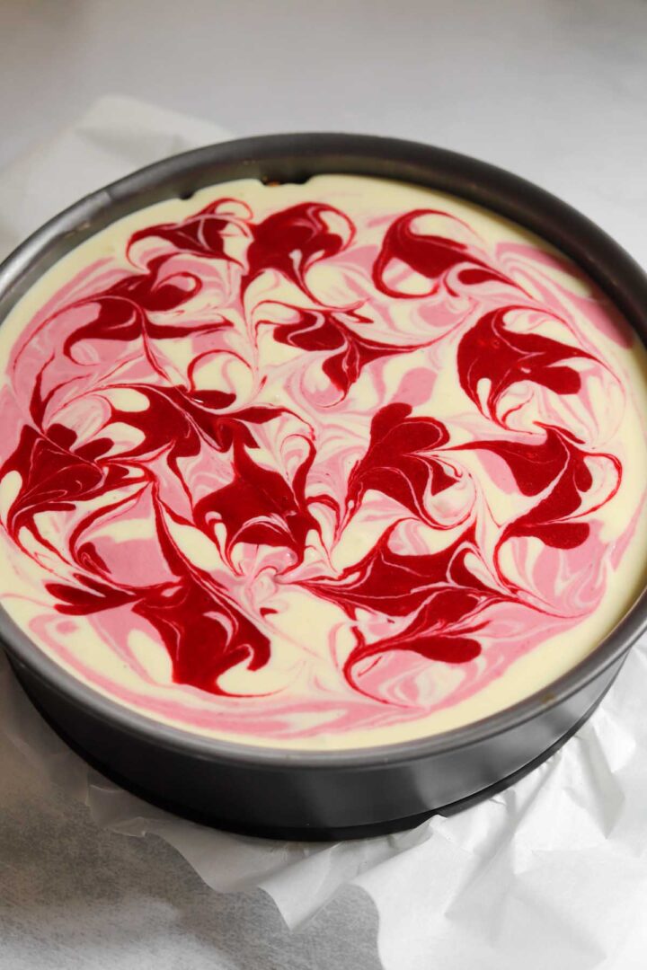raspberry lemonade cheesecake batter in pan before baking