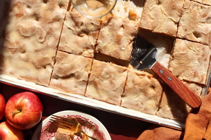 top view of apple fritter Texas sheet cake in baking sheet pan with serving spatula