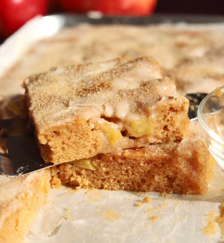apple fritter Texas sheet cake in baking sheet pan with slice cut out on top