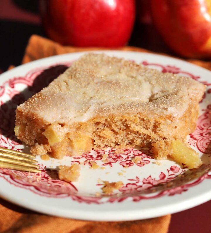 apple fritter texas sheet cake slice on a plate with bite and fork