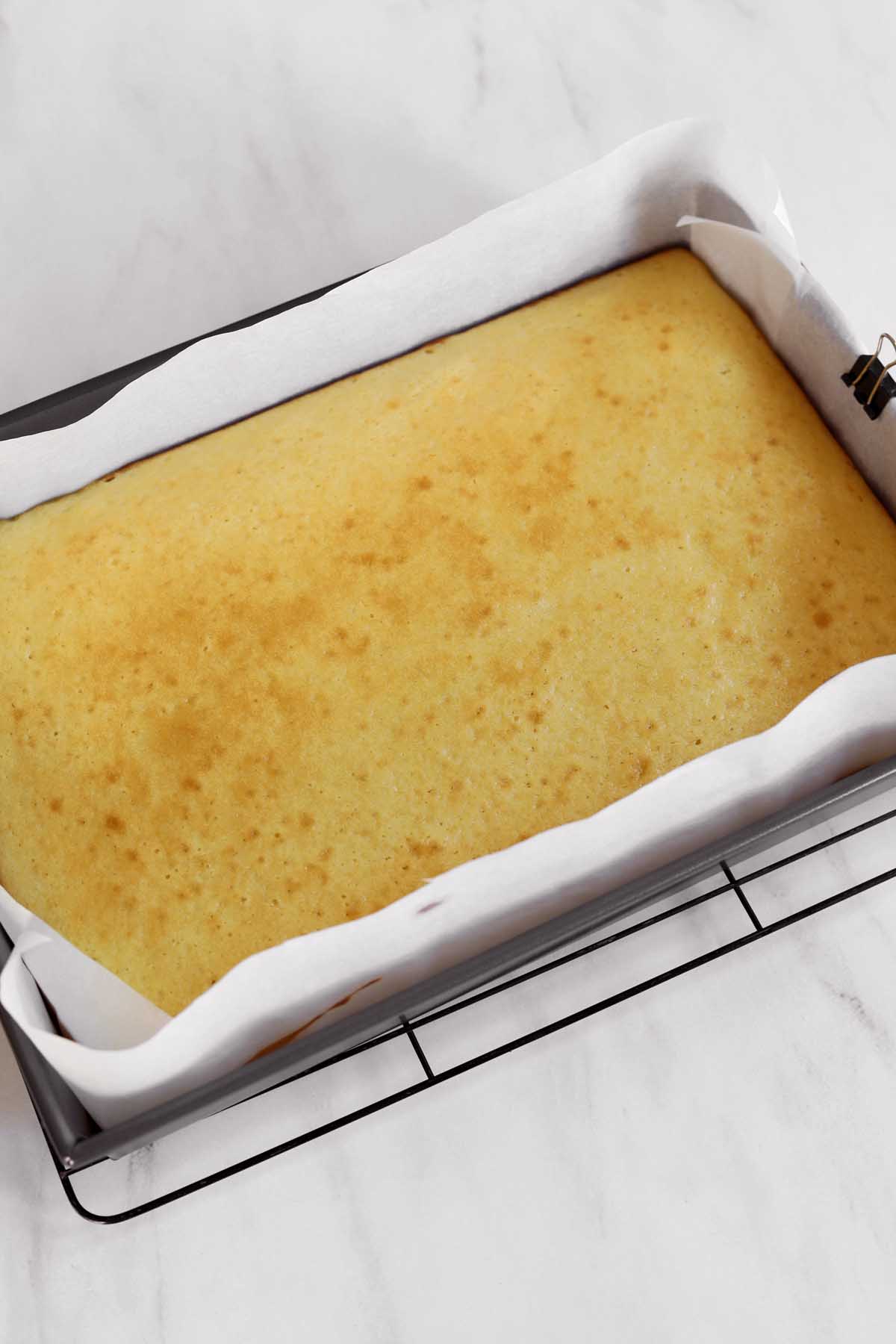moist vanilla sheet cake in baking pan just after baking
