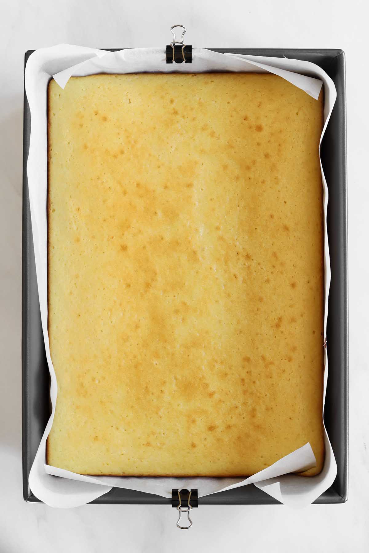 moist vanilla sheet cake in baking pan just after baking