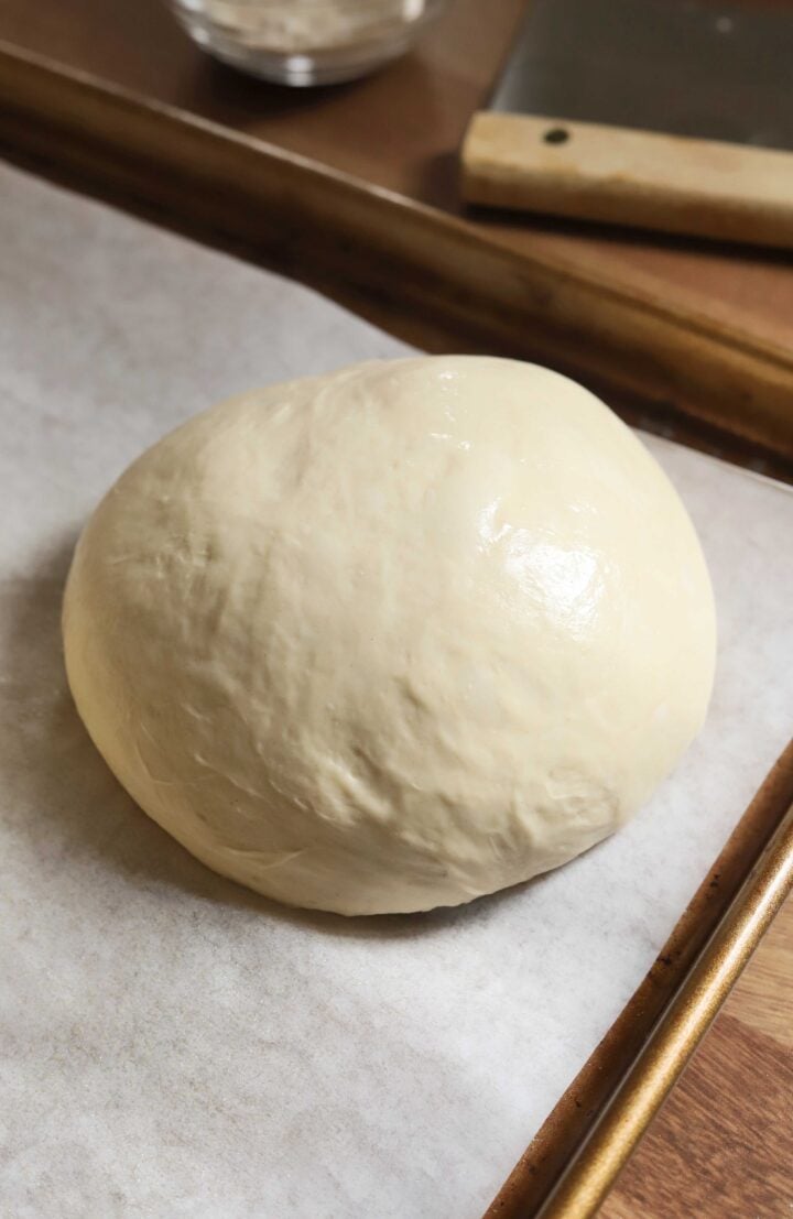 ball of homemade pizza dough after proofing