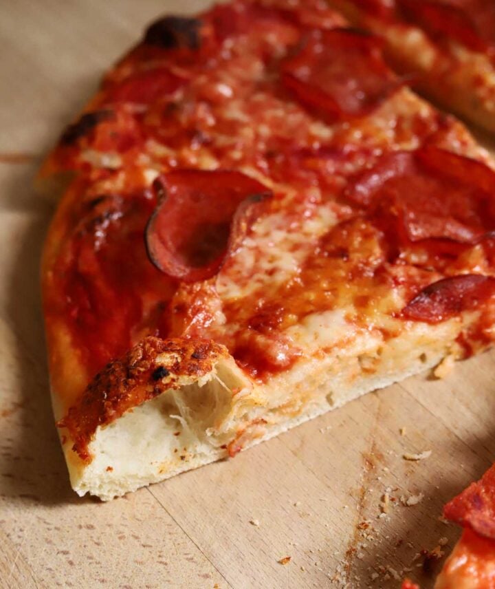 slice of homemade pizza with pepperoni and cheese