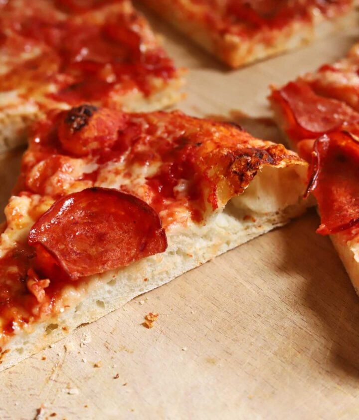 slice of homemade pizza with pepperoni and cheese
