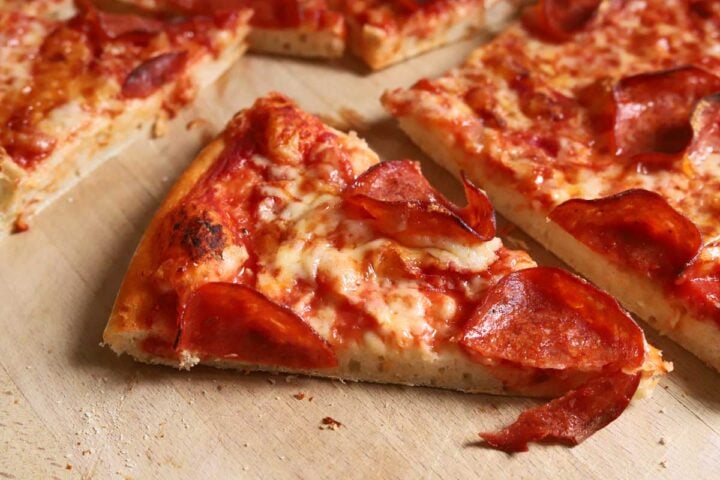 slice of homemade pizza with pepperoni and cheese