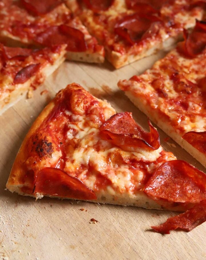 slice of homemade pizza with pepperoni and cheese