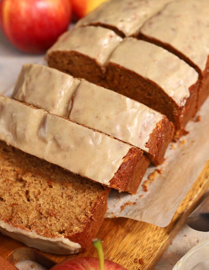 angle view of brown butter apple bread sliced on cutting board with brown butter icing