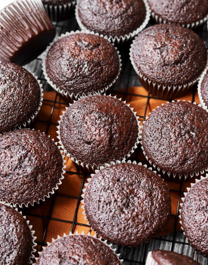 moist chocolate cupcakes cooling on a wire rack