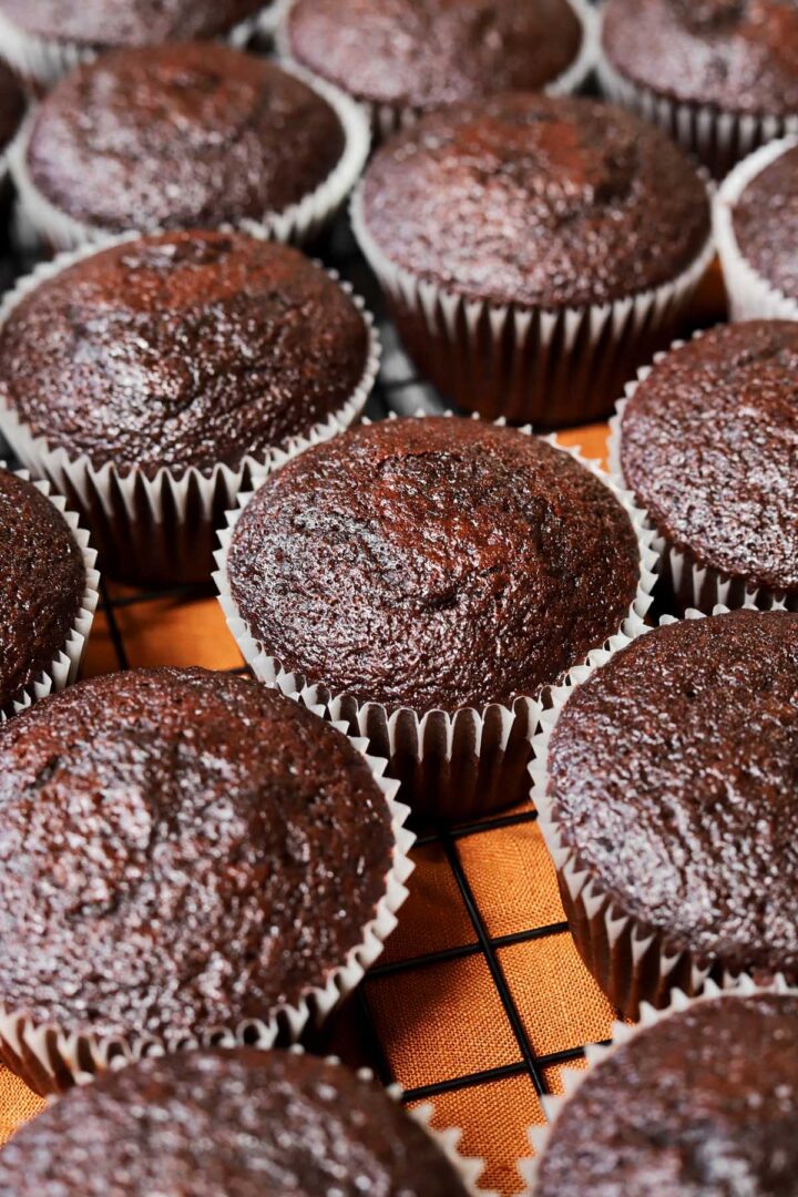 moist chocolate cupcakes cooling on a wire rack