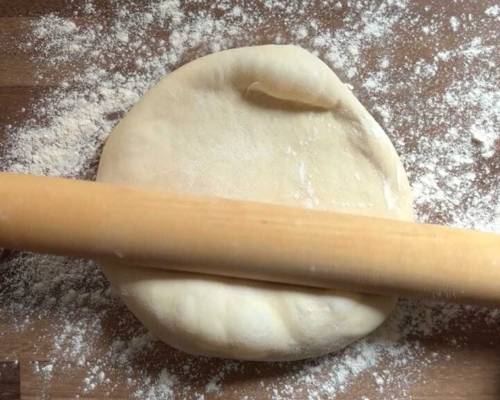Roll the dough ball out on a lightly floured work surface.