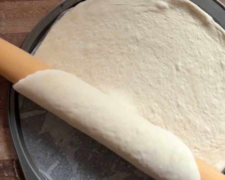 and transfer to an oiled, lined pizza pan or other baking sheet pan.