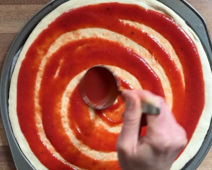 Spread tomato sauce over top.