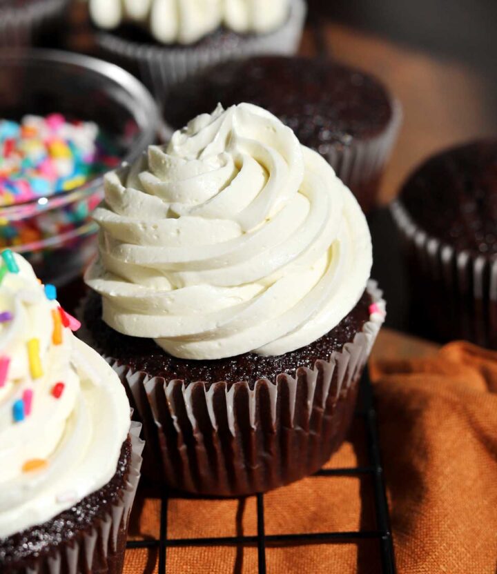 best moist chocolate cupcakes with the best vanilla buttercream frosting piped on top