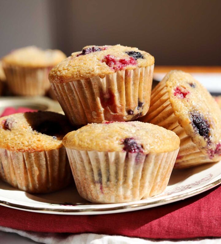 healthy olive oil Greek yogurt berry muffins stacked on a plate