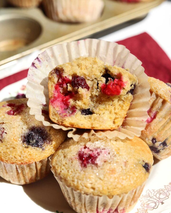 healthy olive oil Greek yogurt berry muffins broken in half showing berries and soft texture